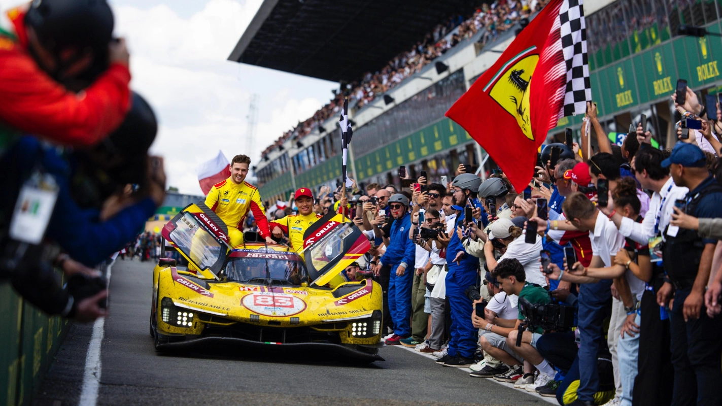 #83 AF Corse Ferrari 499P drivers going to the podium after winning the 2025 Le Mans 24h